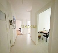 A hallway of a 3-room apartment with a light floor and built-in furniture.