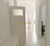 A bright hallway in a 3-room apartment with white walls and furniture.