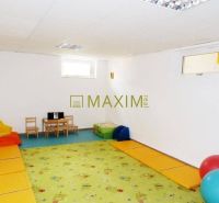 Children's corner in the cabin with colorful mats and a small table with toys.