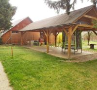A garden by the cottage on Mokráň Záhon in Ružinov with a gazebo and a lawn.