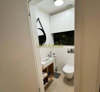 Bathroom with a mirror, sink, and toilet in a 3-room apartment.