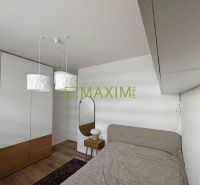 Bedroom in a 3-room apartment with wood-decor flooring, a mirror, and a wardrobe.
