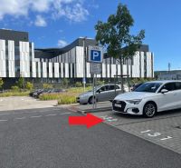 Parking lot with a parking zone sign and a modern building in Bratislava - Lamač.