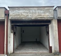 Open garage on Dopravná Street in Piešťany, with a concrete floor and an empty interior.