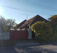 A family house in Veľké Úľany with a wooden gate and greenery in the surroundings.