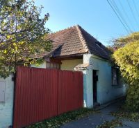 A family house in Veľké Úľany with a historical roof and a wooden fence.
