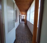 A hallway with a wooden decor floor in a family house.