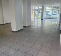 Spacious commercial spaces with large windows and gray tiles.