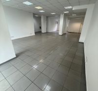 Spacious commercial spaces with tiles and white walls.