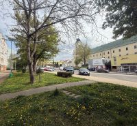 Commercial premises on A. Hlinku Street in Prievidza with a building and cars.