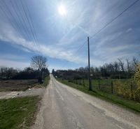 A rural road in Bardoňovo with plots - living surrounded by nature and trees.