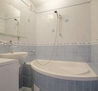 Bathroom in a 3-room apartment with tiles and a bathtub with a sink.