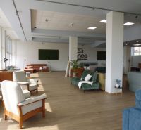 Commercial spaces with comfortable seating and wooden decor flooring.