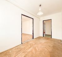 A room in a 3-room apartment with a wooden decor floor and white walls.