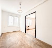 A room with a wooden decor floor in a 3-room apartment.
