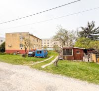 A courtyard with buildings and cars on Hrabovská Street in Trenčín.