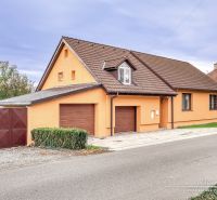 A family house in Špačince on Špačince Street with an orange facade and a brown roof.