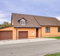 A family house on Špačince Street in Špačince with a pitched roof and a garage.