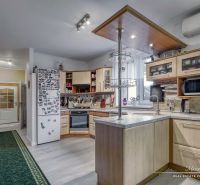 A kitchen in a family house with a wooden decor floor, appliances, and equipment.