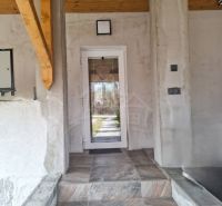 Entrance to a family house in Dolná Strehová with tiles and a wooden ceiling.