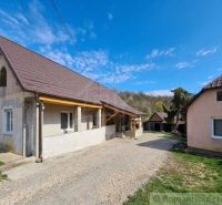 A family house in Dolná Strehová with two buildings and a gravel driveway.
