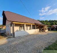 A family house in Dolná Strehová with a veranda and a sloped roof surrounded by nature.