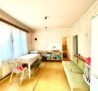 Kitchen in a family house with a dining table and a sofa.