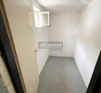 Laundry room in a family house with white walls and a small window.
