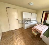 A dining room in a family house with a corner bench, a floor with a wooden decor, and cabinets.