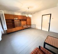A spacious room with retro furniture and white walls in a family house.