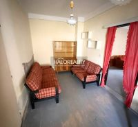 Living room in a family house with sofas and a curtain, capturing the interior.