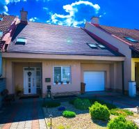 A family house in Rimavská Sobota with a garage and a sunny front garden.