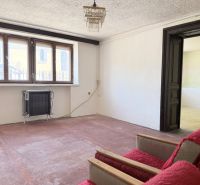 A small room with a sofa, radiator, and a large window, Properties - living.