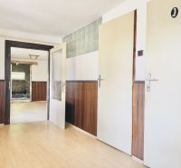 Room with wooden paneling and wood-patterned flooring, Real Estate - Housing.