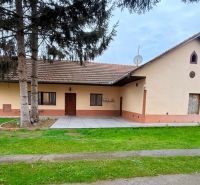 A single-story house with a red roof and a garden in Trenčín on Biskupická, suitable for living.