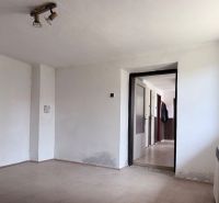 Empty room with white walls and a floor with a wooden decor on Plots - housing.