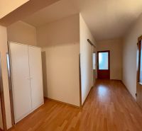 A hallway in a 3-room apartment with a wooden decor floor and a wardrobe.