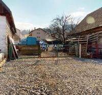 Stone courtyard with wooden buildings in the recreational grounds of Hybie.