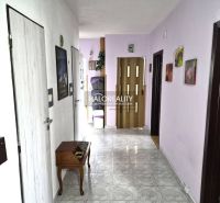 A hallway with entrances to rooms, decorative elements, and part of the furnishings in a 3-room apartment.