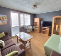 Living room with sofas, a coffee table, and a TV in a three-room apartment.