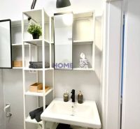 Compact bathroom with open shelves and a sink in a 3-room apartment.