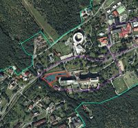 Aerial view of hotels and guesthouses in the High Tatras surrounded by forests and roads.