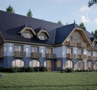 A hotel in the High Tatras with wooden balconies and a stone facade surrounded by greenery.