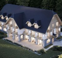 A hotel in the High Tatras with stylish architecture and wooden balconies in a natural setting.