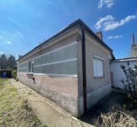 A family house in Bátorove Kosihy with a colorful facade and a concrete walkway.