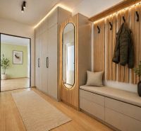 Entrance hall in a 2-room apartment with a wood-patterned floor and designer furniture.