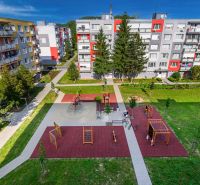 A playground surrounded by apartment buildings on Sládkovičova Street in Fiľakovo, an ideal environment for families.