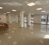 Spacious commercial spaces with shiny floors, columns, and windows for plenty of light.