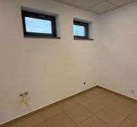 An empty room with two small windows and tiles, commercial space.