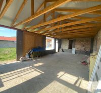An unfinished family house in Encs with visible wooden trusses on a spacious structure.